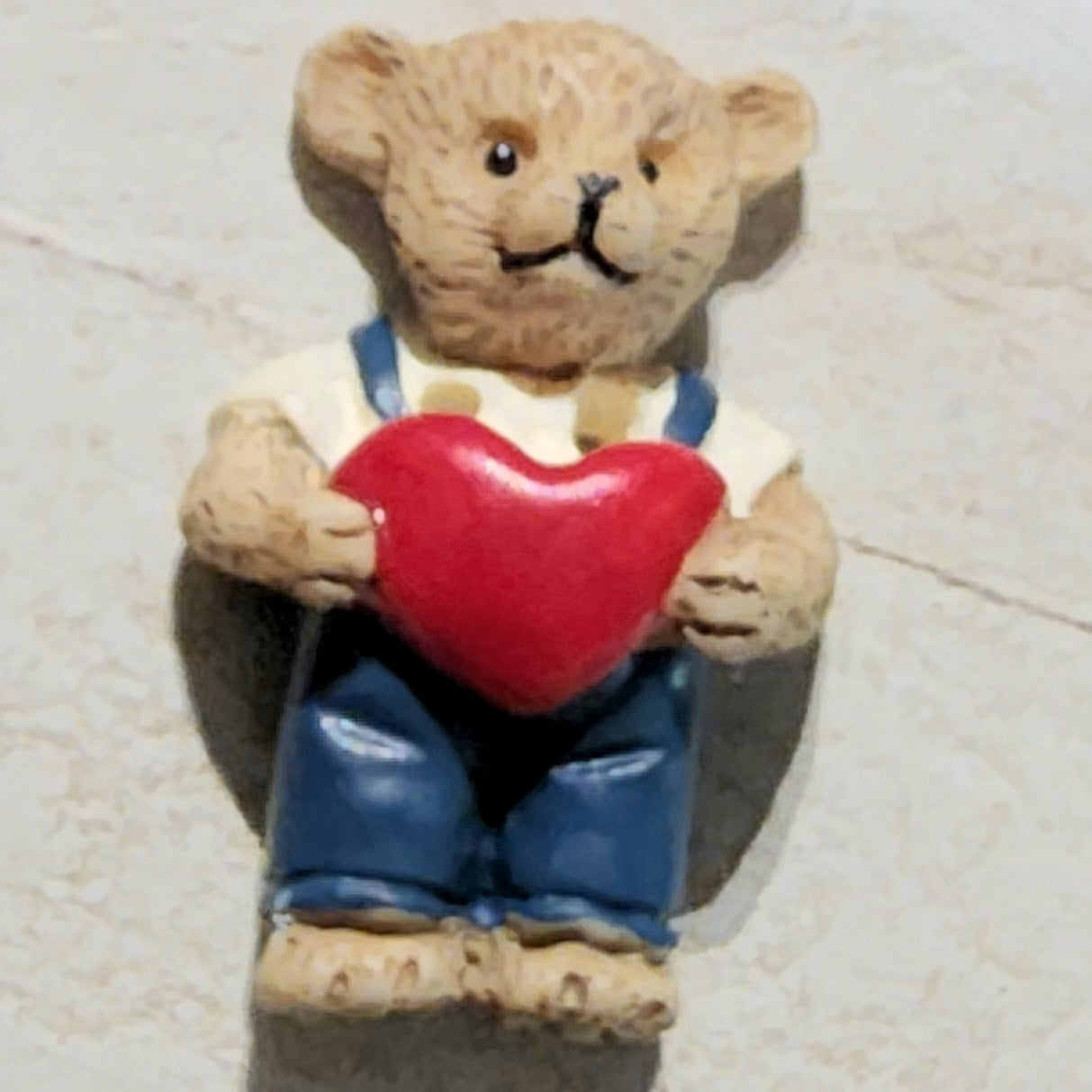 Resin bear holding red heart button 23mm high