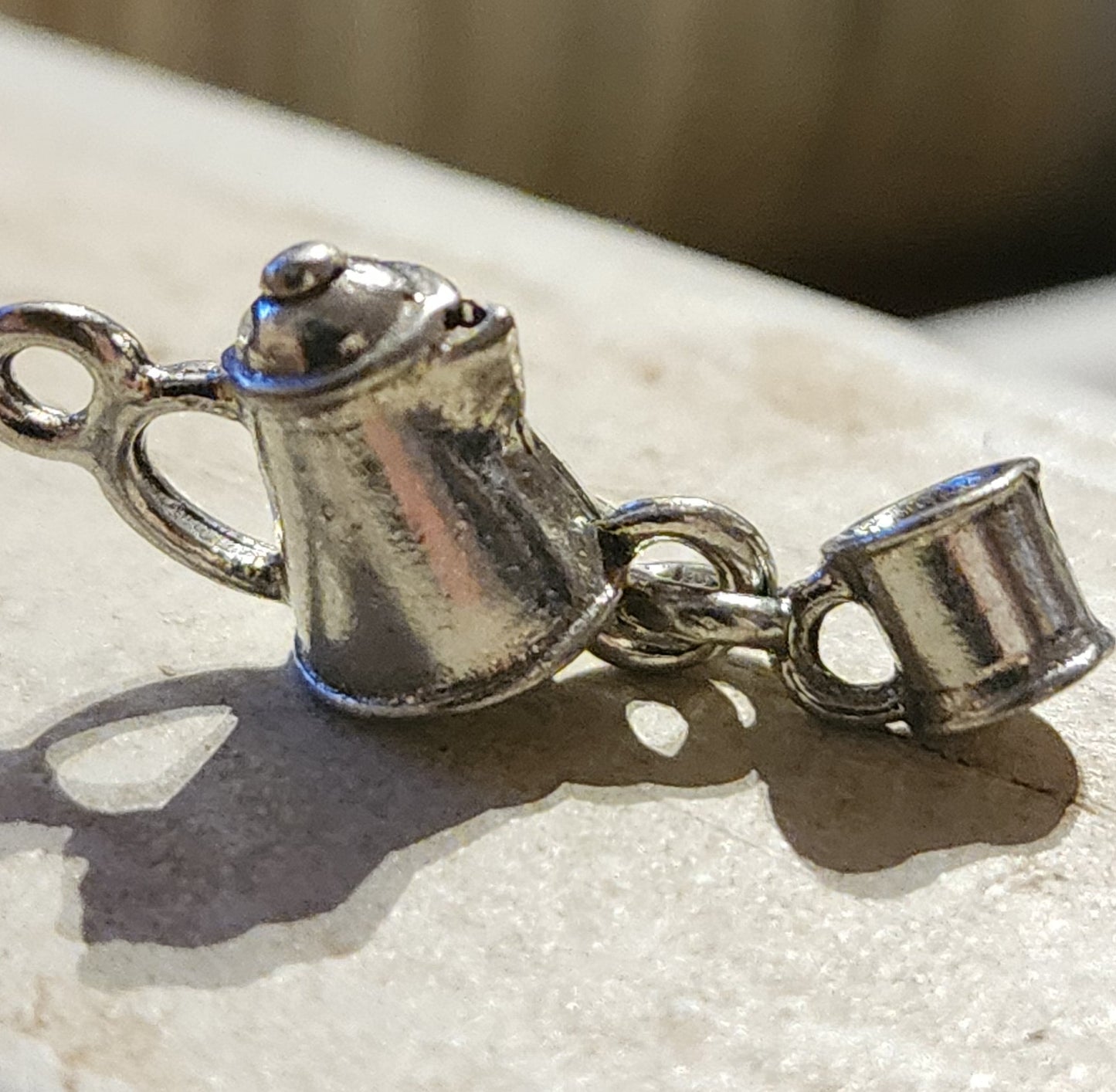 Metal coffee pot with dangling cup charm
