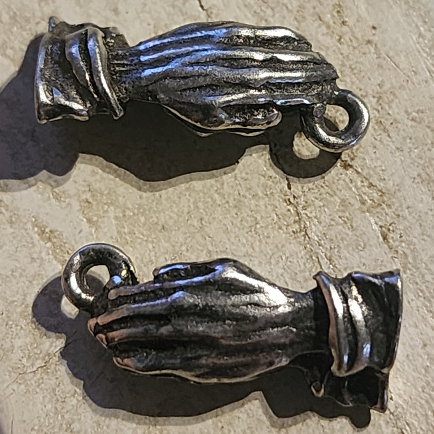 Metal praying hands charm