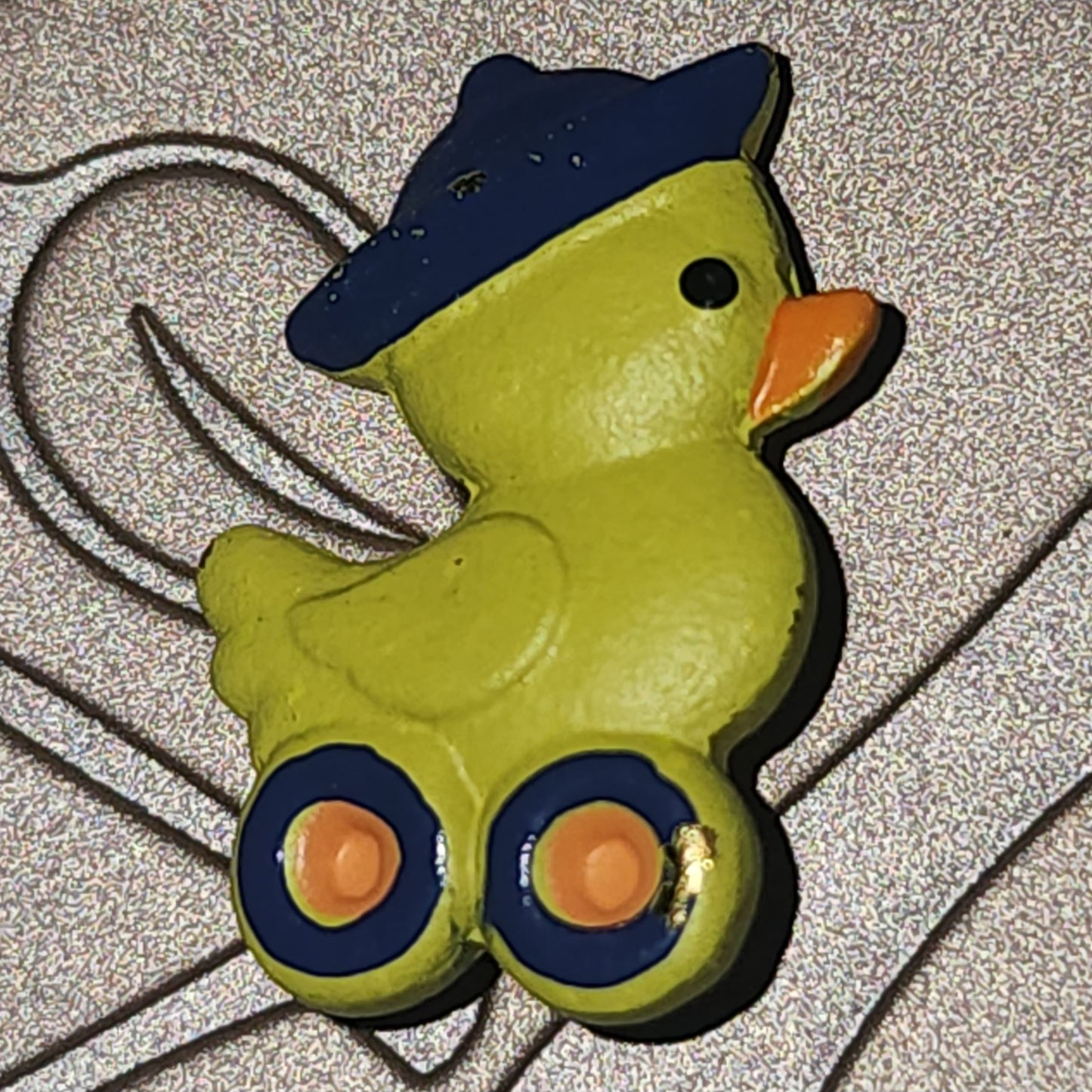 Metal duck on wheels button