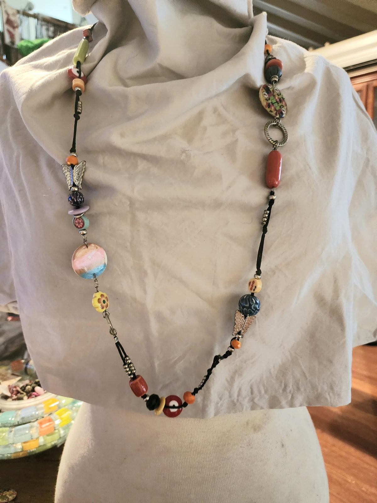 Long mult-bead cord necklace with ceramic and glass beads