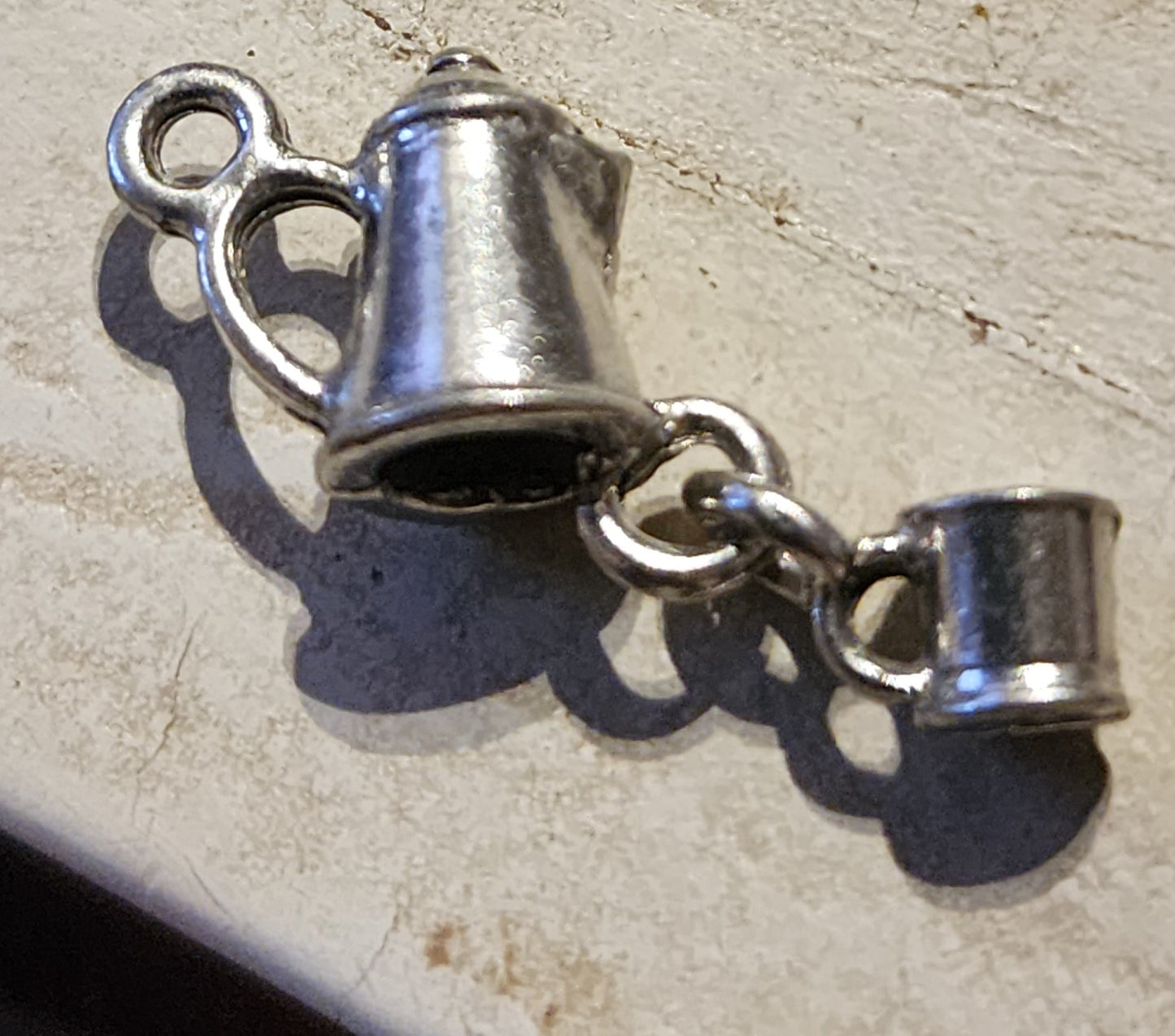 Metal coffee pot with dangling cup charm
